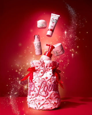Rózsaszín karácsonyi P.Louise táska piros ünnepi masnikkal és ünnepi dizájnnal, piros alapon testápoló termékekkel